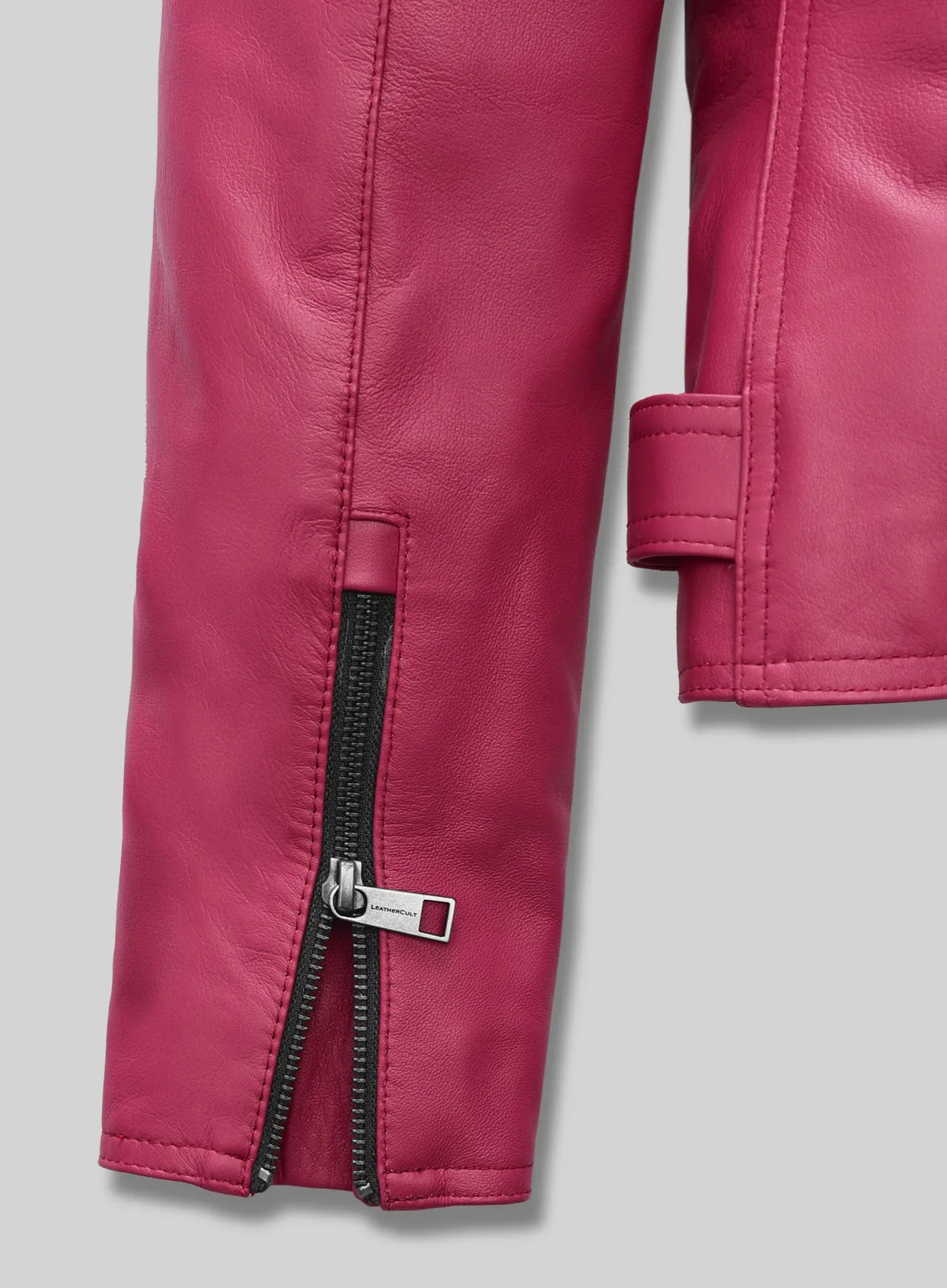 Close-up of zipped sleeve cuff on a pink leather biker jacket