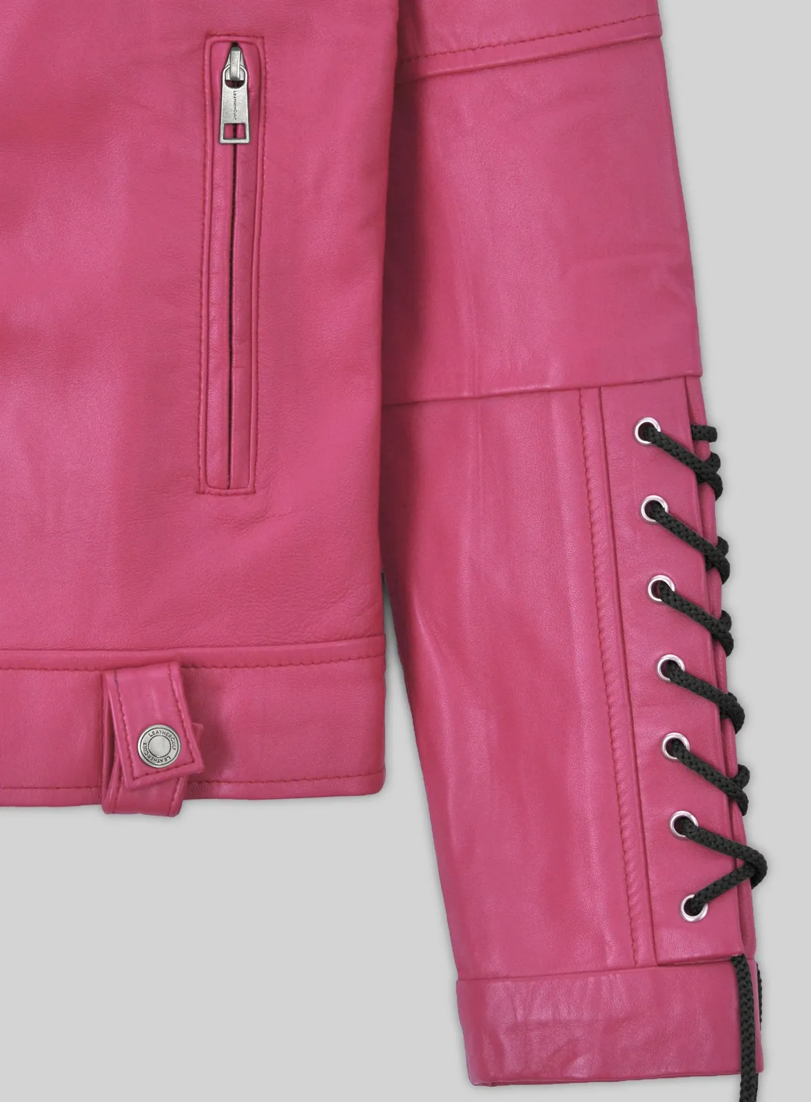Close-up of pink leather jacket zip pocket, waist tab and black lace-up sleeve