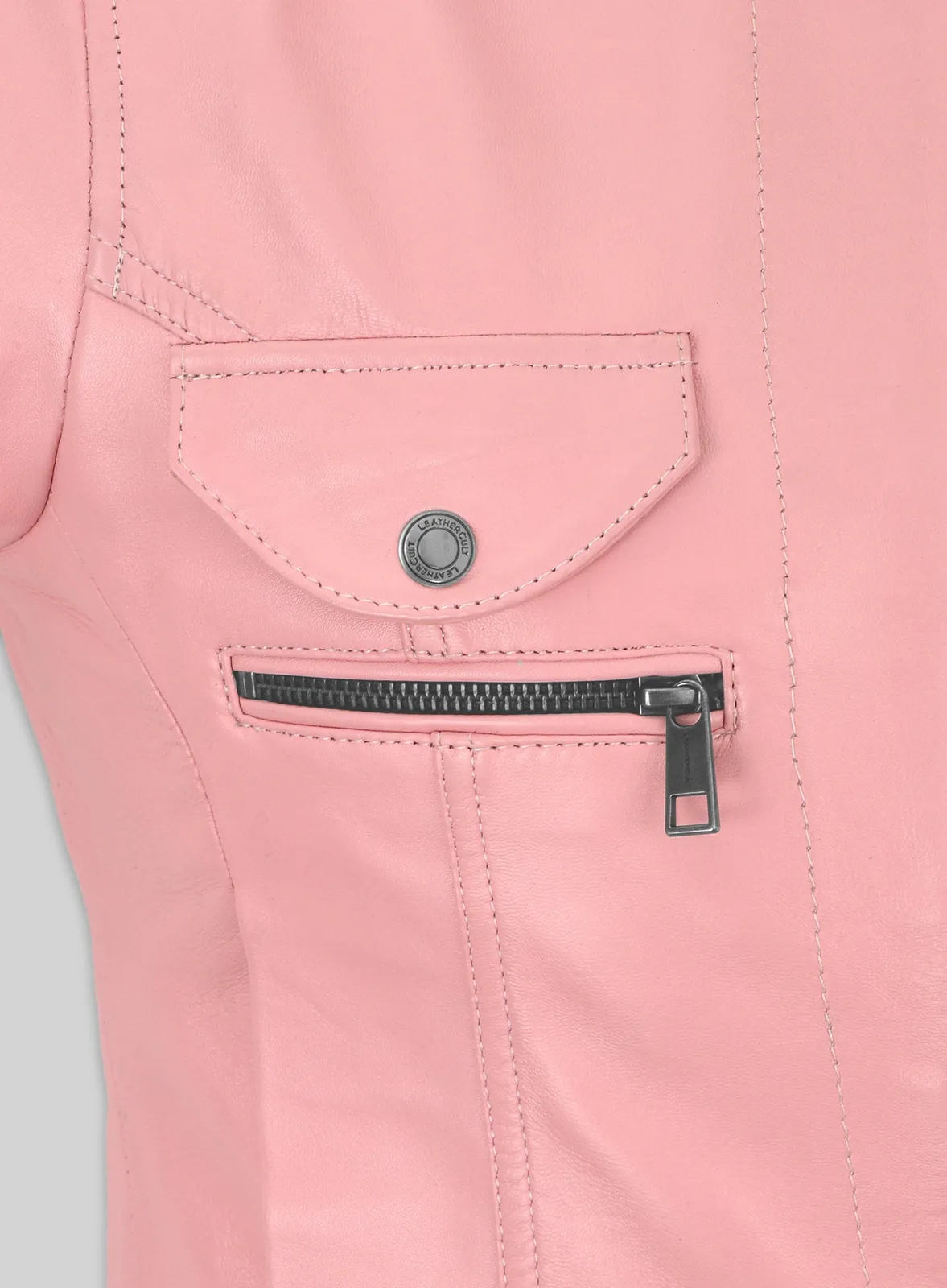 Close-up of flap pocket with snap and zip pocket on a pink leather jacket