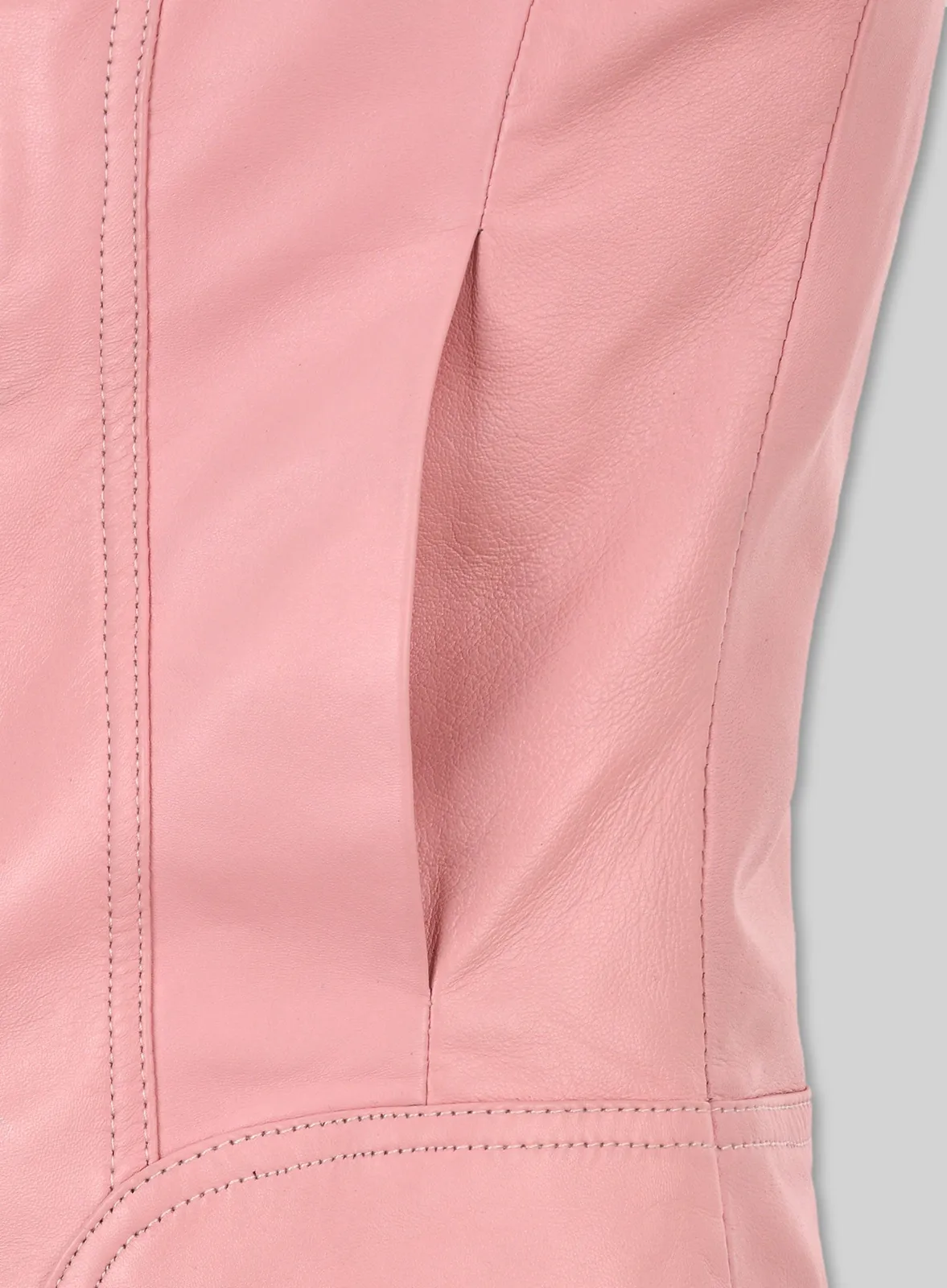 Close-up of side slit pocket and stitched seams on a pink leather jacket