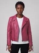 Woman wearing a pink leather biker jacket with lace-up sleeves and tassels