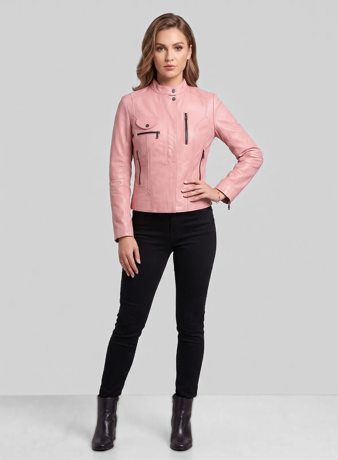 Woman wearing a light pink leather jacket with stand collar and zip pockets, full-length view