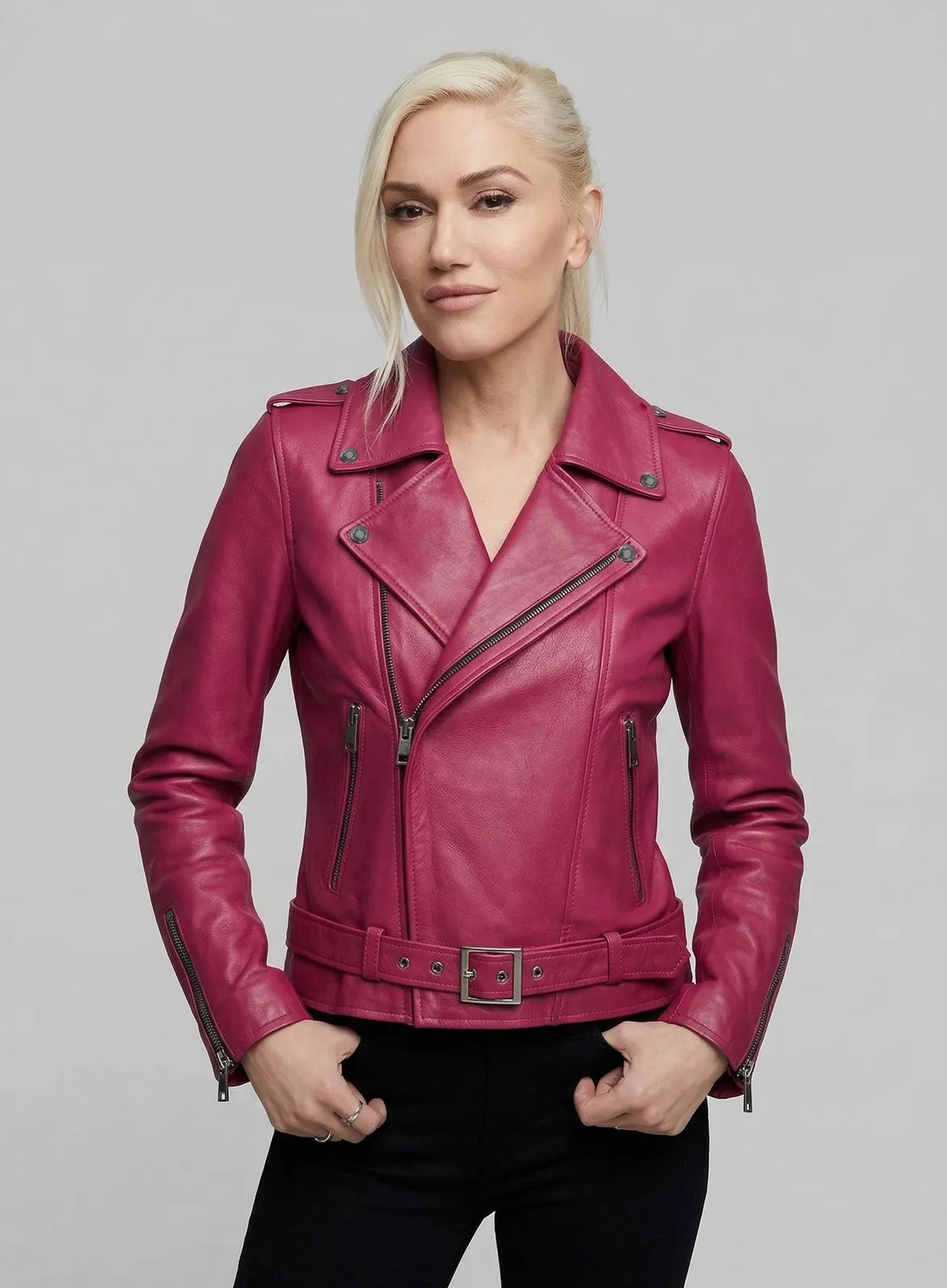Woman wearing a Gwen Stefani inspired pink leather biker jacket, close view of lapel and belt