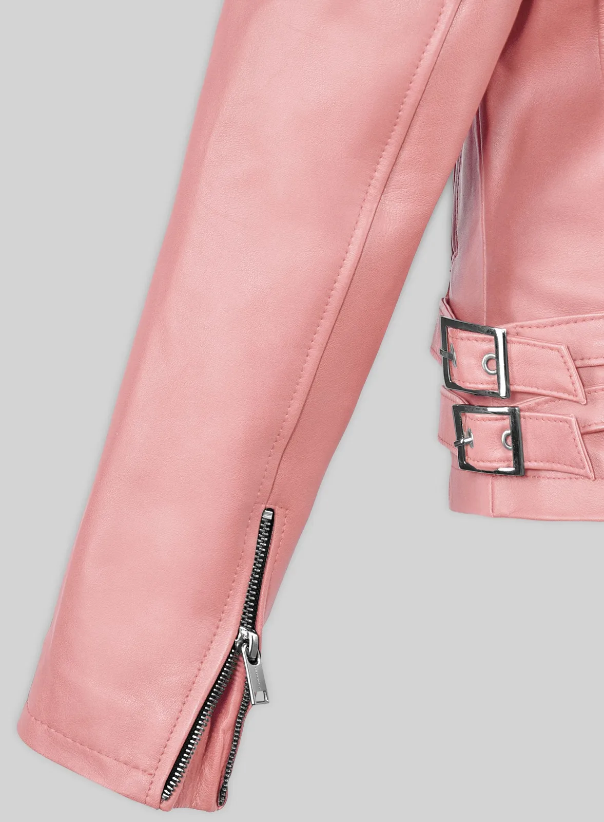 Close-up of pink leather jacket sleeve with zip cuff and double buckle waist straps