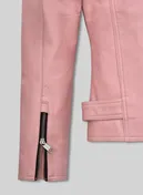 Close-up of zippered sleeve cuff and waist tab on a light pink leather jacket