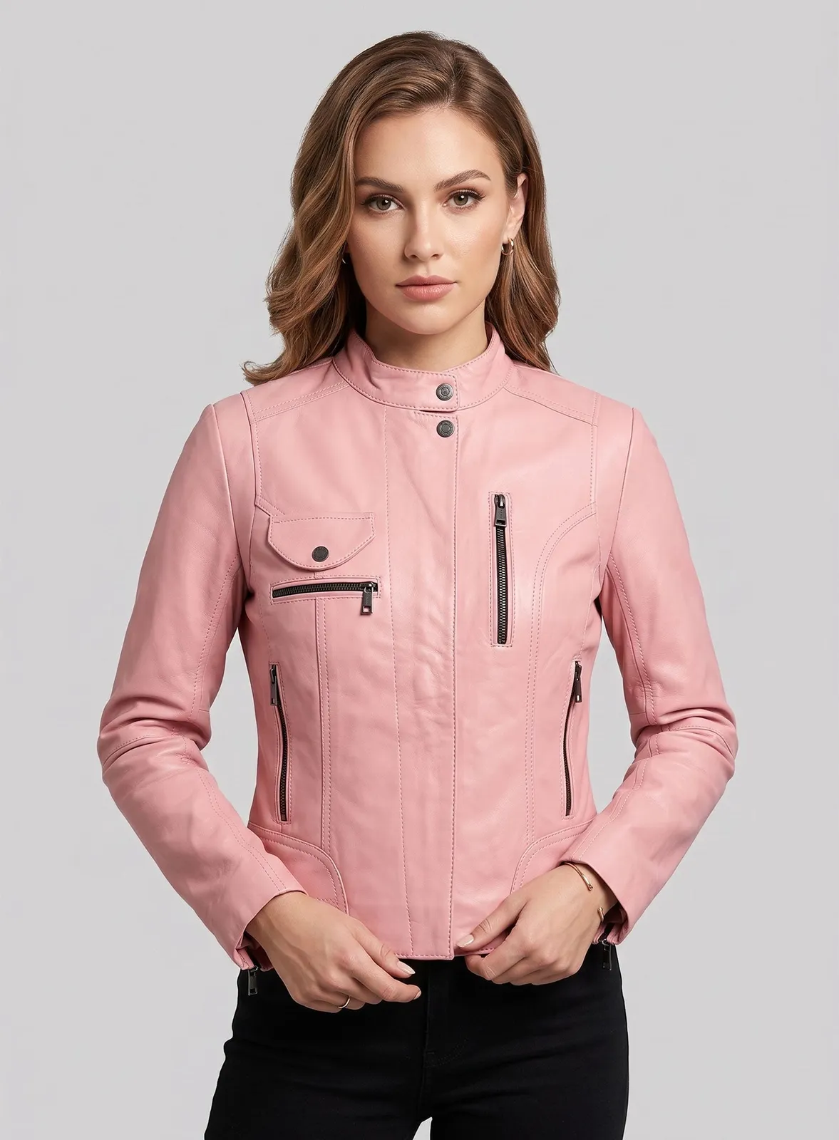 Close-up of a woman in a light pink leather jacket with stand collar and zip pockets