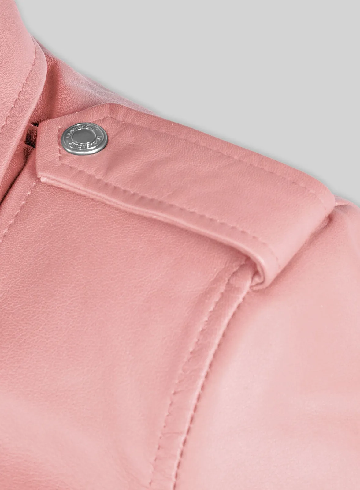 Detail of pink leather jacket epaulette with metal snap button