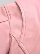 Close-up of shoulder seam and stitching on a light pink leather jacket